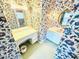 Bathroom with hexagon tiled floors and vanity area, with floral wallpaper at 315 Crescent Dr, Clayton, NC 27520