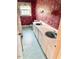 Bathroom showcasing double sinks, vanity with storage and red floral wallpaper at 315 Crescent Dr, Clayton, NC 27520