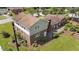 Aerial image showing a brick home with an attached 2-story living quarter on a verdant lawn at 315 Crescent Dr, Clayton, NC 27520