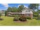 Charming two-story brick home featuring lush landscaping, well-manicured lawn, and classic black shutters at 315 Crescent Dr, Clayton, NC 27520