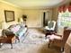 Cozy living room featuring carpeted floors and natural light, decorated with traditional furniture at 315 Crescent Dr, Clayton, NC 27520