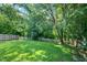 The backyard is lush and green and features a white picket fence at 3201 Sawyers Mill Dr, Apex, NC 27539