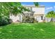 Picture of the backyard with a screened porch, mature trees, and lush green grass at 3201 Sawyers Mill Dr, Apex, NC 27539
