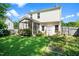 A spacious backyard with a screened porch, and garden beds at 3201 Sawyers Mill Dr, Apex, NC 27539