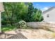 Landscaped backyard featuring a stone patio, wood fence and mature flowering bushes at 3201 Sawyers Mill Dr, Apex, NC 27539