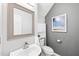 Modern half bathroom with a stylish mirror, vanity, and ample storage space at 3201 Sawyers Mill Dr, Apex, NC 27539