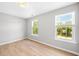 Bright bedroom with wood floors, neutral paint, and large windows at 3201 Sawyers Mill Dr, Apex, NC 27539