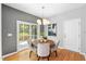 Charming dining area with natural light, hardwood floors, and stylish modern chandelier at 3201 Sawyers Mill Dr, Apex, NC 27539