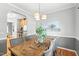 Bright and modern dining room featuring hardwood floors and modern light fixtures at 3201 Sawyers Mill Dr, Apex, NC 27539