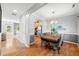Elegant dining room with stylish lighting and a large, wooden table with seating for eight at 3201 Sawyers Mill Dr, Apex, NC 27539
