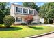 Charming two-story home with yellow siding, green shutters, a welcoming front porch, and a well-manicured lawn at 3201 Sawyers Mill Dr, Apex, NC 27539