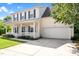 Traditional two-story home with a covered porch, attached garage, and lush green lawn at 3201 Sawyers Mill Dr, Apex, NC 27539