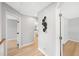 Upstairs hallway featuring wood-look floors, fresh paint, and neutral decor at 3201 Sawyers Mill Dr, Apex, NC 27539