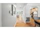 Hallway featuring hardwood floors that lead to a cozy living space and dining area at 3201 Sawyers Mill Dr, Apex, NC 27539