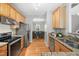 Spacious kitchen featuring stainless steel appliances and open layout into the dining area at 3201 Sawyers Mill Dr, Apex, NC 27539