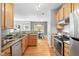Well-equipped kitchen boasts stainless steel appliances, granite countertops, and wooden cabinets at 3201 Sawyers Mill Dr, Apex, NC 27539