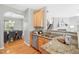 Open-concept kitchen showcasing granite countertops and stainless steel appliances, flowing into dining at 3201 Sawyers Mill Dr, Apex, NC 27539