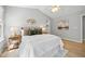 This main bedroom boasts a high vaulted ceiling, neutral walls, and a decorative gold accent over the headboard at 3201 Sawyers Mill Dr, Apex, NC 27539