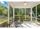 This screened porch features a ceiling fan and views of the landscaped backyard at 3201 Sawyers Mill Dr, Apex, NC 27539