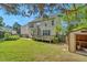 Spacious backyard with green grass, wood deck, exterior shed, and privacy fence at 3212 Marblewood Ct, Raleigh, NC 27604