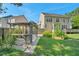 Large backyard featuring green grass, a wooden pergola, and mature trees at 3212 Marblewood Ct, Raleigh, NC 27604