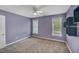 Spacious bedroom with two windows, carpeted floor, and a ceiling fan at 3212 Marblewood Ct, Raleigh, NC 27604