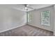 Bedroom with carpet, ceiling fan and two large windows for ample natural light at 3212 Marblewood Ct, Raleigh, NC 27604
