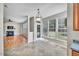 Eat-in kitchen area with large windows, adjacent to living space with fireplace and hardwood floors at 3212 Marblewood Ct, Raleigh, NC 27604