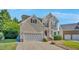Well-maintained two-story home with neutral siding, brick steps, two-car garage and landscaped yard at 3212 Marblewood Ct, Raleigh, NC 27604