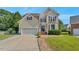Traditional two-story home with manicured lawn, brick steps, neutral siding, and attached two car garage at 3212 Marblewood Ct, Raleigh, NC 27604