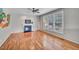 Cozy living space with hardwood floors, gas fireplace, ceiling fan, and large windows overlooking the yard at 3212 Marblewood Ct, Raleigh, NC 27604