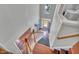 View of a staircase with wood railings, leading to a front door with an open view to the outside at 3212 Marblewood Ct, Raleigh, NC 27604