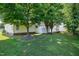 A well-maintained backyard featuring lush green grass and mature trees, providing a serene outdoor space at 325 Millet Dr, Morrisville, NC 27560