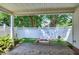 A covered patio space with a brick-paved floor leads to the backyard area with plants and privacy fence at 325 Millet Dr, Morrisville, NC 27560