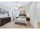 Cozy bedroom featuring neutral tones, carpet flooring, a ceiling fan, and an ensuite bathroom for added convenience at 325 Millet Dr, Morrisville, NC 27560