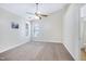 Spacious bedroom with plush carpet flooring, two windows that fill the room with natural light, and an adjacent bathroom at 325 Millet Dr, Morrisville, NC 27560