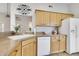 Kitchen area with ample counter space, white appliances, and wood cabinetry, offering a functional cooking environment at 325 Millet Dr, Morrisville, NC 27560