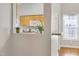 Pass-through view of a kitchen equipped with wood cabinets, a white microwave, and stylish decor elements at 325 Millet Dr, Morrisville, NC 27560