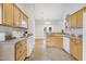 Functional kitchen showcasing white appliances, wooden cabinets, and a tile floor, designed for practical meal preparation at 325 Millet Dr, Morrisville, NC 27560