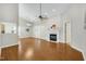 Spacious living room featuring hardwood floors, a ceiling fan, a fireplace, and a neutral color scheme throughout at 325 Millet Dr, Morrisville, NC 27560
