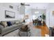 Inviting living room with a gray sofa, round coffee table, and a dining area with a table set for four at 325 Millet Dr, Morrisville, NC 27560