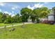 Spacious backyard with a well-manicured lawn and mature trees at 401 N Main St, Louisburg, NC 27549