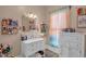 Bright bathroom with a large mirror, vanity, and natural light at 401 N Main St, Louisburg, NC 27549