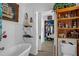 Bright and airy bathroom with a bathtub, nautical decor, and a peek at a walk-in closet at 401 N Main St, Louisburg, NC 27549