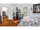 An airy bedroom with a rocking chair, hardwood floors, and classic decor at 401 N Main St, Louisburg, NC 27549