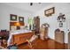 A bright bedroom with vintage decor, a wooden bed, a closet and wooden floors at 401 N Main St, Louisburg, NC 27549