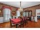 Formal dining room with wood floors, chandelier, patterned wallpaper, and a large table for elegant gatherings at 401 N Main St, Louisburg, NC 27549