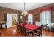 Formal dining room with elegant chandelier, hardwood floors, and ample seating for Gathering gatherings at 401 N Main St, Louisburg, NC 27549