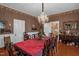 Charming dining room featuring wood floors, floral wallpaper, vintage furniture, and a bright chandelier at 401 N Main St, Louisburg, NC 27549
