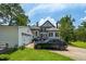 Traditional two-story house featuring well-maintained landscaping and a two-car garage at 401 N Main St, Louisburg, NC 27549